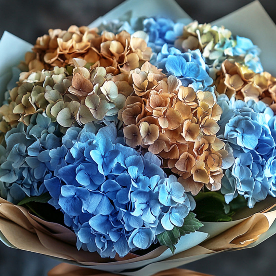 Elegant bouquet of blue and golden dried hydrangeas wrapped in luxe kraft paper — an artistic floral composition by Flowers Lounge by Iness, perfect for refined home décor or thoughtful gifting