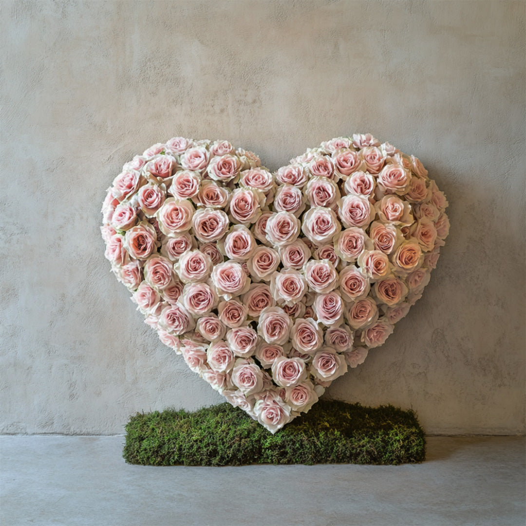 Elegant heart-shaped flower arrangement made with soft pink roses on a moss base. A beautiful floral tribute handcrafted by Flowers Lounge by Iness, available for delivery across Los Angeles and surrounding cities.
