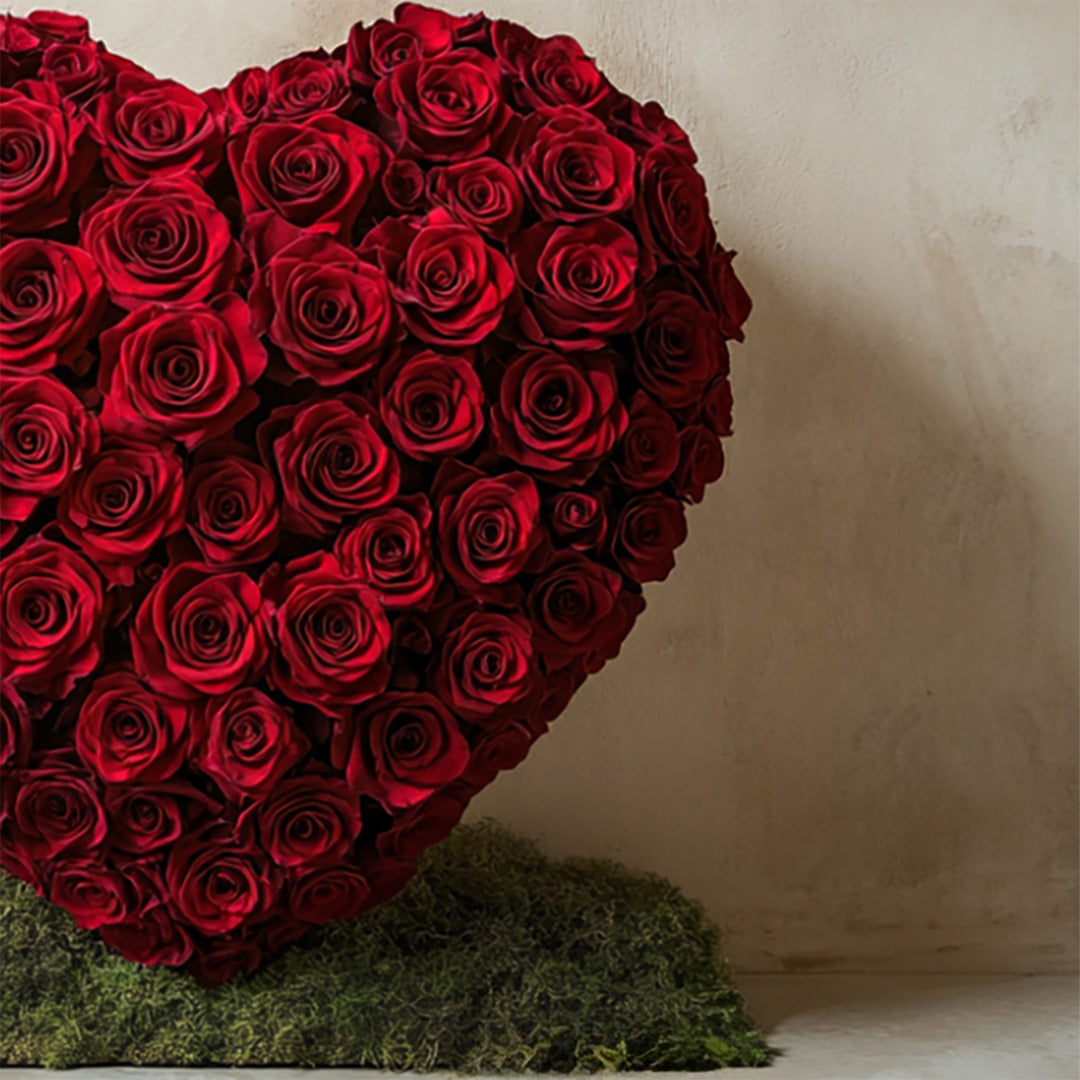 Striking heart-shaped arrangement of deep red roses, symbolizing passion and love. Presented on a lush moss base by Flowers Lounge by Iness — a romantic centerpiece perfect for anniversaries or Valentine’s Day, available for delivery in Los Angeles.
