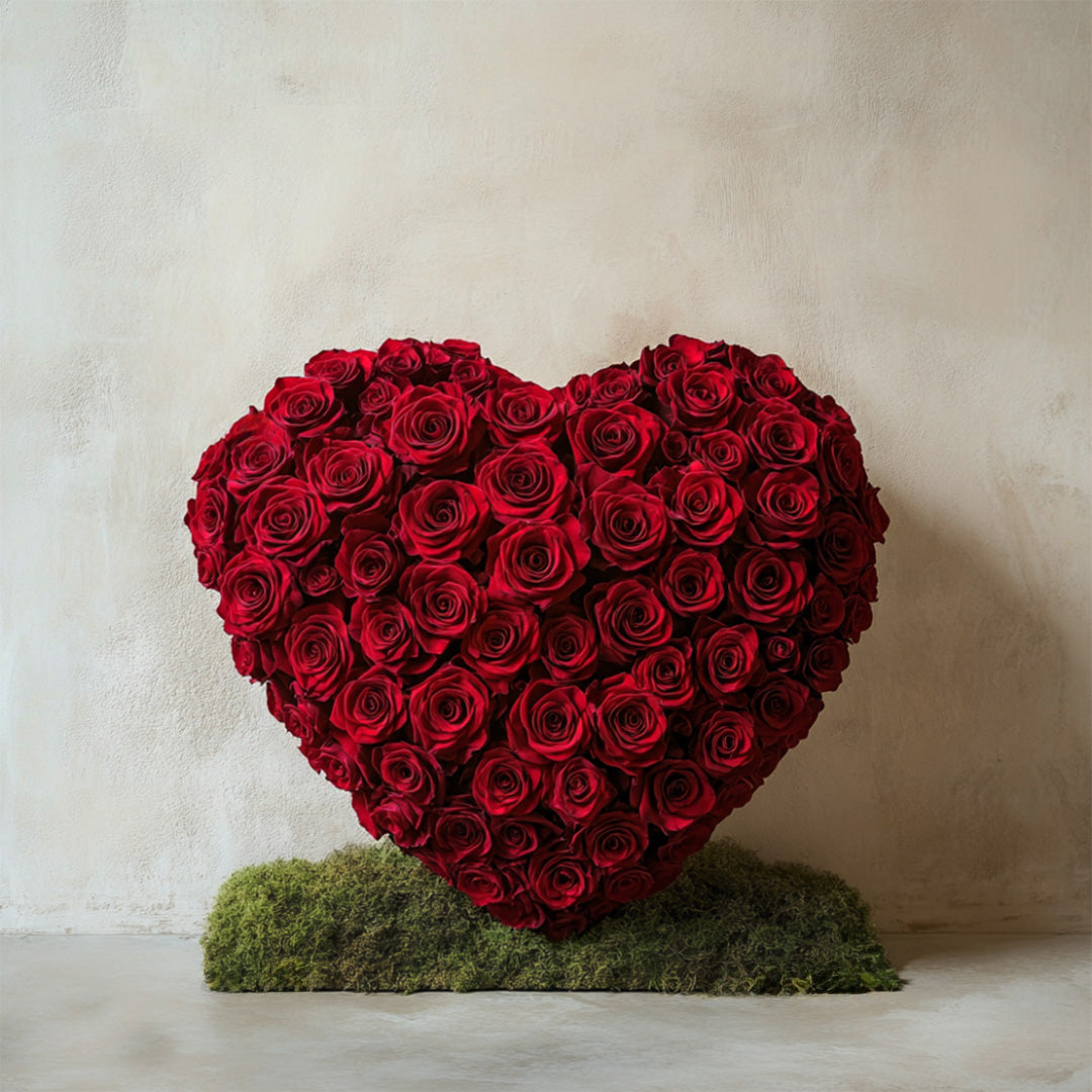 Elegant heart-shaped arrangement of vibrant red roses, beautifully crafted and set on a natural moss base. A timeless romantic gift by Flowers Lounge by Iness, perfect for anniversaries, proposals, or Valentine’s Day.