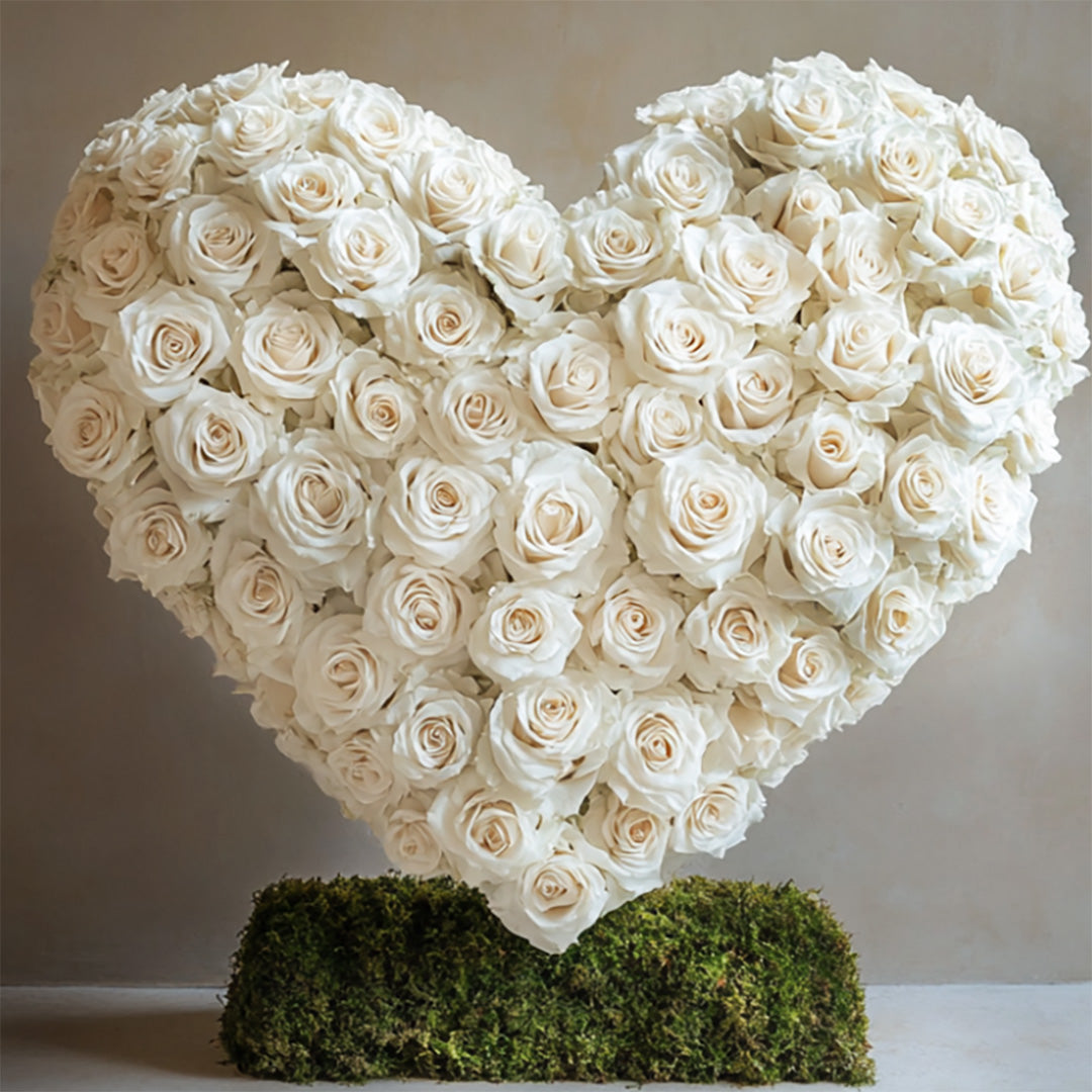 Heart-shaped arrangement of elegant white roses displayed on a bed of moss — a timeless floral tribute by Flowers Lounge by Iness. Available for delivery across Glendale, Pasadena, Arcadia, and all of Los Angeles