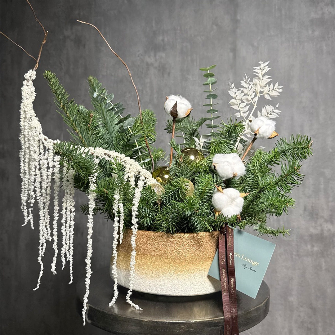 Golden Pine holiday arrangement with cotton stems, evergreens, gold ornaments, and cascading amaranthus in a gold vase – festive floral gift in Los Angeles