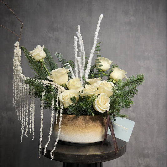 White roses and evergreen pine in gold ceramic vase – Snow Rose holiday flower arrangement